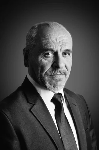 Sophisticated black and white portrait of a senior man in a suit, exuding elegance and wisdom.